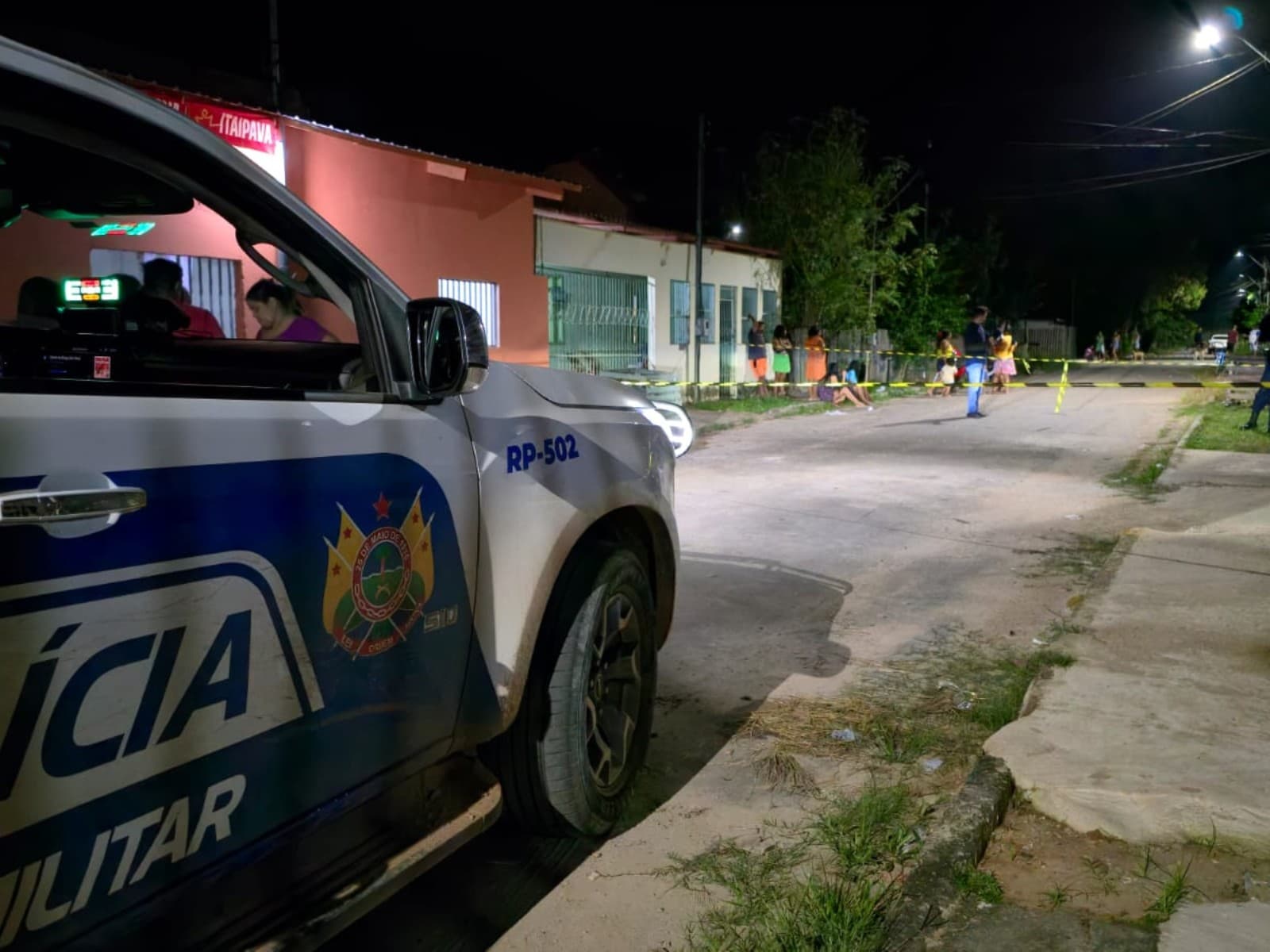 Viatura policial e fita de isolamento em rua de bairro residencial em Brasiléia, no Acre.