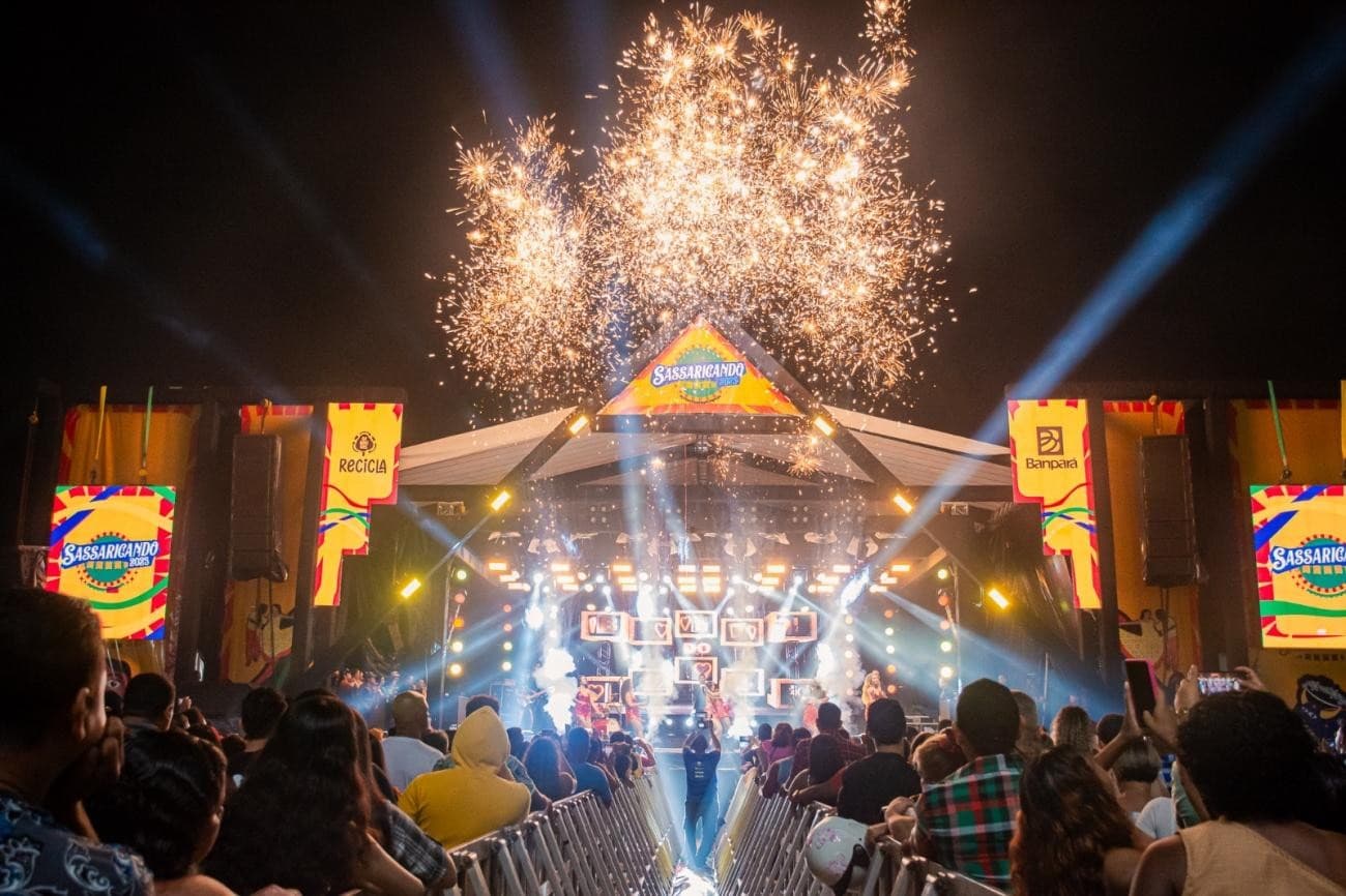 Vista do Ginásio Nagibão em Benevides iluminado para o festival Sassaricando com público ao redor.